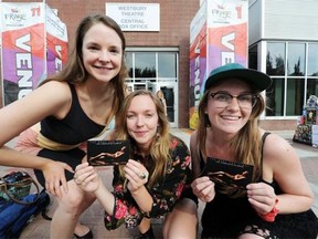From left, Allison Burns, Linnea Gwiazda and Stephanie Morin-Robert from Montreal were on hand passing out cards for their show called For Body and Light on the Fringe site in Edmonton on Tuesday.