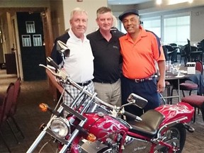 From left, Tom Burns poses with MLAs George VanderBurg and George Rogers with the motorcycle Burns won at an auction during a fundraiser for Rogers.