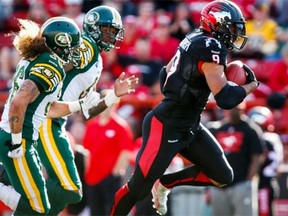 From left, Edmonton Eskimos defensive backs Aaron Grymes, left, and Patrick Watkins chase Calgary Stampeders running back Jon Cornish during the Labour Day Classic, a 28-13 Eskimos loss, on Sept. 1, 2014 at McMahon Stadium.