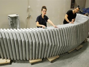 From left, Shawna Heide and husband Matt Heide of Concrete Cat work on a concrete reception desk that they are making for a company in Edmonton.