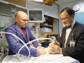 Dr. Georg Schmolzer (left) and Dr. Po-Yin Cheung demonstrate an innovative new resuscitation technique being tested in a clinical trial at the Royal Alexandra Hospital on September 8, 2014 in Edmonton which is giving hope to parents whose children need medical assistance moments after being born.