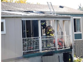 Glen Stoby looks at his mobile home in Castle View Village, near 153rd Avenue and 127th Street after fire destroyed the building and sent his brother and a rescuer to hospital.