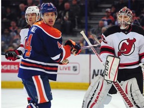 Goalie Cory Schneider, right, with Taylor Hall at the net in the Edmonton Oilers game against the New Jersey Devils at Rexall place in Edmonton on Friday, Nov. 22, 2014.
