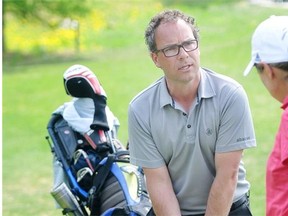 Golf professional Mike Belbin works with a golfer at the Royal Mayfair Golf Club on May 20, 2013.