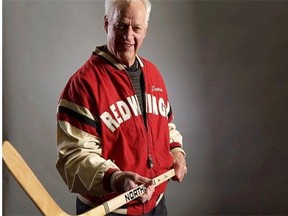 Gordie Howe is shown a handout photo from the book “Mr. Hockey.”