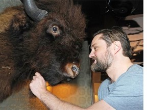 Al Gothjelpsen, managing partner and director of operations at Denizen Hall, next to a buffalo head in the new pub/music venue in the Grand Hotel in Edmonton