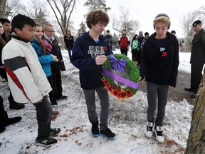 Grade 9 students Kasyn Kennedy and Anthony Steinke from Winterburn school lay a wreath for the No Stone Left Alone Remembrance Ceremony at Mount Pleasant Cemetery in Edmonton on Friday Nov. 8, 2013.