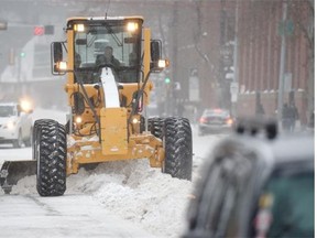 Graders clear snow from 102 Avenue downtown as the winter storm continues in Edmonton on Friday Nov 28, 2014.