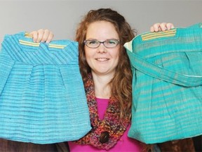 Amy Roy Gratton holds up two bags for sale at a Nov. 16 craft show. Some bags were sewn out the clothing donated from a friend from India.