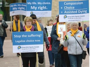 A group marches at the Dying With Dignity rally held at City Hall and Churchill Square in downtown Edmonton on Wednesday, Oct. 15, 2014.