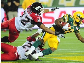 AJ Guyton (82) is tackled by Deron Mayo (42) and Jamar Wall (29) as the Edmonton Eskimos were defeated 26-22 by the Calgary Stampeders on Thursday at Commonwealth Stadium. General manager Ed Hervey is impressed with the progress his club has made this season, in spite of Thursday’s loss.