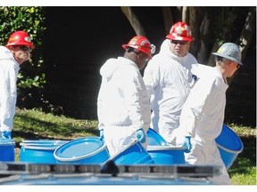 Hazmat workers with Protect Environmental unload barrels in preparation for decontaminating an apartment at The Village Bend East apartment complex where a second health care worker who has tested positive for the Ebola virus resides on October 15, 2014 in Dallas, Texas. Nurse Amber Vinson joins Nina Pham as health workers who have contracted the Ebola virus at Texas Heath Presbyterian Hospital while treating patient Thomas Eric Duncan, who has since died. (Photo by Mike Stone/Getty Images)
