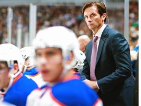 Head coach Dallas Eakins of the Edmonton Oilers looks on from the bench during their NHL game against the Vancouver Canucks at Rogers Arena October 11, 2014 in Vancouver, British Columbia, Canada.