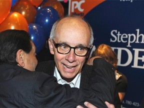 Health Minister Stephen Mandel is hugged by a supporter after winning the provincial Edmonton-Whitemud riding by-election for the Progressive Conservatives in Edmonton, October 27, 2014.