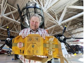 Inside the Alberta Aviation Museum, Cliff Adams holds a parachute that belonged to LAC Butch, the dog who was 418 Squadron’s mascot in the 1950s. Tony Cashman writes that Butch was both agreeable and curious, and was well cared for.