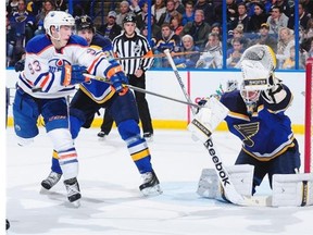 Jake Allen #34 of the St. Louis Blues defends the net against Ryan Nugent-Hopkins #93 of the Edmonton Oilers on November 28, 2014 at Scottrade Center in St. Louis.