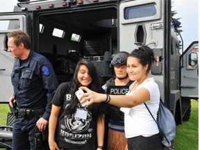 Jalisa Taypotat and Tori Musqua take a selfie with the tactical unit. The Aboriginal Youth Police Academy builds relationships with the EPS while building leadership skills.