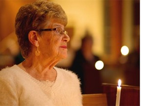 Jane Orydzuk holds a candle during the Victims of Homicide Support Society annual memorial for homicide victims at the Strathearn United Church on Dec. 11, 2014. Jane’s son Tim was murdered in 1996 and a killer was never brought to justice.