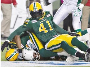 Edmonton Eskimos defensive end Odell Willis ends up on top of a pile of bodies involving Saskatchewan Roughriders quarterback Tino Sunseri during Friday’s Canadian Football League game at Commonwealth Stadium.