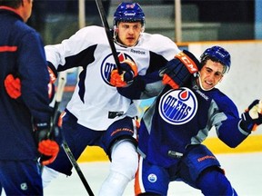 Oilers first round draft pick, centre Leon Draisaitl (L) #55 takes down denfenceman #77 Joey Laleggia as they take part in the Edmonton Oilers annual prospect development camp in Jasper, July 3, 2014.