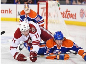 Jeff Petry (2)of the Edmonton Oilers, falls with Martin Hanzal (11) of the Arizona Coyotes at Rexall Place in Edmonton.