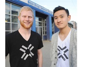 Joel Wegner, left, and Nicholas Yee are setting up the Street Store Oct. 25 at Boyle Street Community Services. Wegner and Yee are wearing T-shirts from their clothing line, Multiplying Equality, where all the money goes to charitable organizations