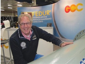 C. J. de Jong, sales manager for GC Clad, based in the Netherlands, sets up a display of the company’s two-layer Fedur pipe steel at the oil sands trade show and conference opening Tuesday in Fort McMurray.