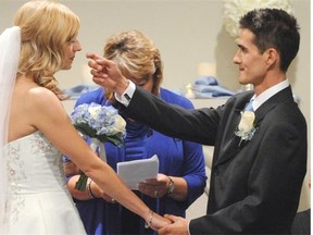 Josh Melnyk about to wipe a tear from his bride Megan Wolfe at their wedding. The bride is gravely ill with cancer and has less than a year to live. They tied the knot at the Union Bank Inn in Edmonton, August 20, 2014.