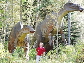 Jurassic Forest near Gibbons features dinosaur replicas amid the trees.