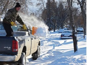 You know when Edmonton has got lots of snow when you see people, like Hank Bodewitz, who have to shovel snow out of the back of their pickup truck on Friday, Nov. 28, 2014.