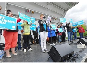 Lee Kvern from the Friends of Michener Centre speaks to hundreds of people during a protest outside the Alberta Tory policy conference at the Radisson Hotel South in Edmonton on May 25, 2013.