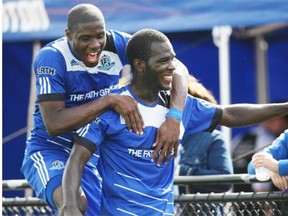 Lance Laing celebrates his fourth goal of the season with FC Edmonton teammate Kareem Moses during the second half of Sunday’s North American Soccer League game against the Fort Lauderdale Strikers at Clarke Field.