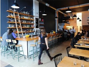 Landon Schedler’s woodwork is seen in the tables, shelving and bar top at Woodwork, 10132 100th St.