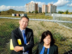 Coun. Michael Walters and area resident Mattie Matheson pose at Century Park in southwest Edmonton. It was supposed to be the city’s premier transit-oriented development when it commenced almost eight years ago, but work has halted at the site.