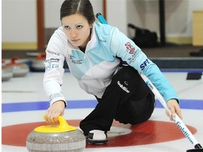 Laura Crocker demonstrates one option to hold a curling broom for balance while throwing a rock.