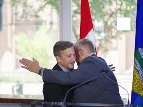 MP Laurie Hawn hugs James Cumming after introducing him at Cumming's campaign announcement in August.