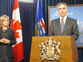 At the legislature Thursday, Premier Jim Prentice announces his government is putting on hold a bill that legislates on gay-straight alliances in schools. Critics say the bill institutionalizes discrimination of homosexuals. Beside Prentice is PC backbencher Sandra Jansen, who sponsored the bill.