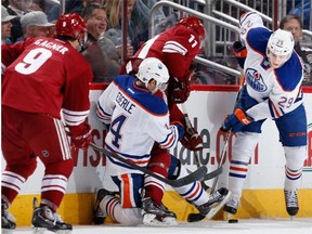 Leon Draisaitl (R) #29 of the Edmonton Oilers attempts to control the puck during the second period of the NHL game against the Arizona Coyotes at Gila River Arena on December 16, 2014 in Glendale, Arizona.