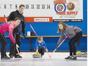 From left, Heather, David and daughters Alyssa, 9, in the hack, and 12-year-old Halle, right, formed a family curling team this season at the Sherwood Park Curling Club.