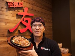 Izakaya Tomo restaurant owner and chef Tomoya Mutaguchi displays his signature dish Tonpei Yaki.