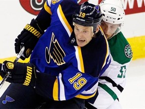 St. Louis Blues defenseman Jay Bouwmeester (19) and Dallas Stars left wing Derek Hulak (50) battle for the puck in the third period of a preseason NHL hockey game at the Sprint Center in Kansas City, Mo., Saturday, Sept. 27, 2014. The Stars won 4-2.