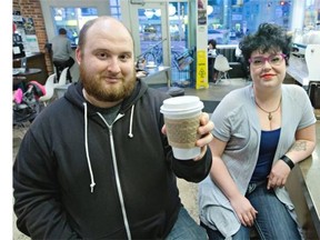 Marina Reid Hale, right, was thrilled to have a poem published on coffee sleeves being handed out at independent coffee stores such as Transcend Garneau. She was approached to join the project by Jason Lee Norman, left, writer-in-residence for the Edmonton Public Library, who spent his own cash to publish the short works of local writers on the compostable sleeves.