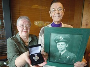 Mary Holland is photographed with Fred Wallingford in Vancouver, B.C., on Oct. 22, 2014. In 1952, Holland found a Memorial Cross belonging to Wallingford’s brother Donald, in a ditch in Mission, B.C.