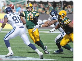 QB Matt Nichols gets hurried by Tristan Okpalaugo in the first half during a game between the Edmonton Eskimos and Toronto Argonauts in Commonwealth Stadium on Aug. 23, 2014.