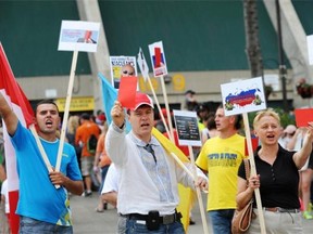 Members of the Edmonton branch of the Ukrainian Canadian Congress protest Russia's hosting of the 2018 FIFA World Cup prior to the start of the women's Under-20 World Cup quarter-final at Commonwealth Stadium on Aug. 16, 2014.