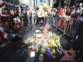 Members of the media and onlookers gather at a makeshift memorial at the star of actor-comedian Robin Williams along the Hollywood Walk of Fame in Los Angeles on Tuesday. Williams, 63, died at his San Francisco Bay Area home Monday in an apparent suicide.