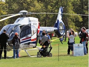 Members of the public check out the Edmonton Police Service helicopter, Air-1, in Hawrelak Park during Emergency Preparedness Week in May 2013.