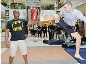 Mixed martial arts fighters Mukai Maromo (left) and Shane “Shaolin” Campbell (right) participate in an open training session at City Centre Mall in Edmonton on Wednesday October 1, 2014 in preparation for Maximum Fighting Championship 41 which will be held in Edmonton on Friday October 3, 2014.