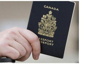 A passenger holds his Canadian passport before boarding a flight.