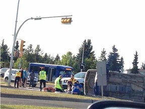 Firefighters tend to the injured after a two-vehicle crash on 23rd Avenue and 111th Street on Aug. 23, 2014.